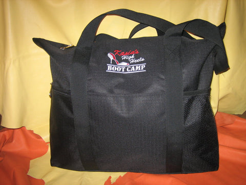 Black tote bag with zipper and small zipper and mesh packets on the side.
